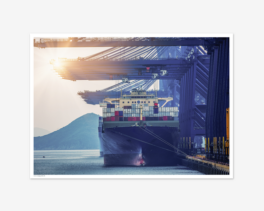 Containerskib i havnen ved solnedgang